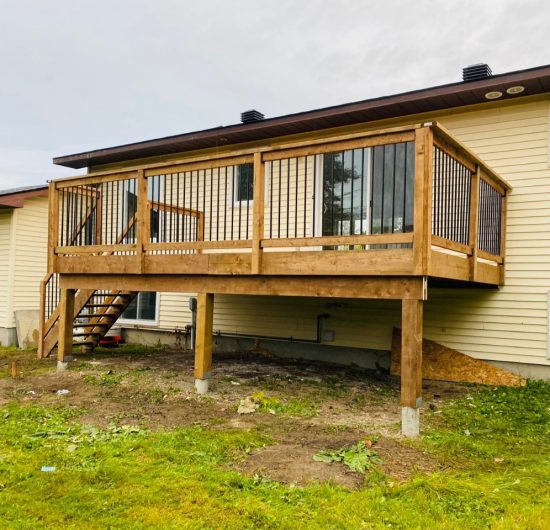 Contemporary hallway with wooden staircase, black metal railing, and clean white interior design by Prime Built.