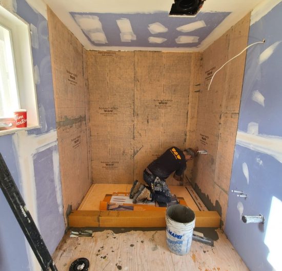 Modern kitchen with sleek cabinets and large island by Prime Built
