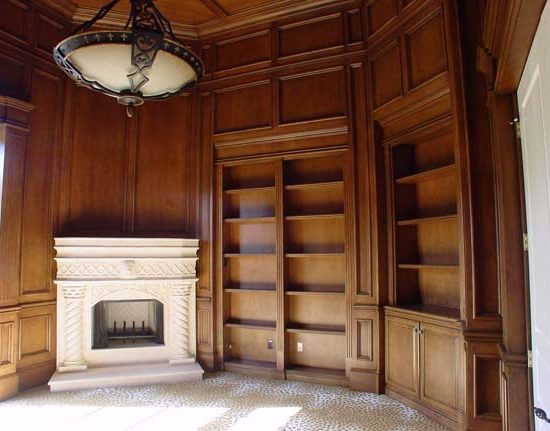 Custom woodwork featuring a fireplace with white mantel, built-in shelves, and elegant detailing by Prime Built.