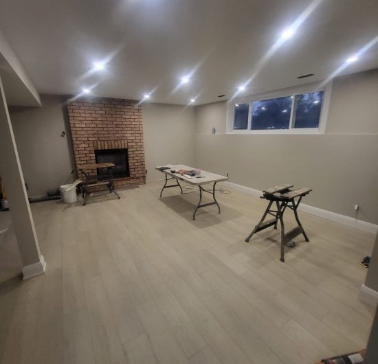 Construction worker balancing on wooden beams while aligning roof trusses on a new residential build.