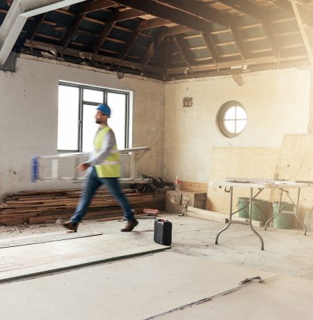 Modern two-story custom home with a flat roof, wood accents, and large windows designed by Prime Built.