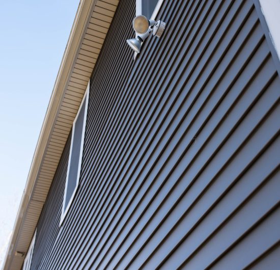 Close-up of modern dark grey exterior siding on a contemporary home.